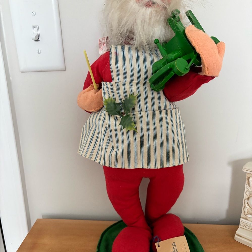 Festive Santa Figurine with Green Toy
